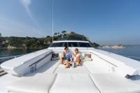 SANDI-IV yacht charter: Guest relaxing on the foredeck sunbathing area